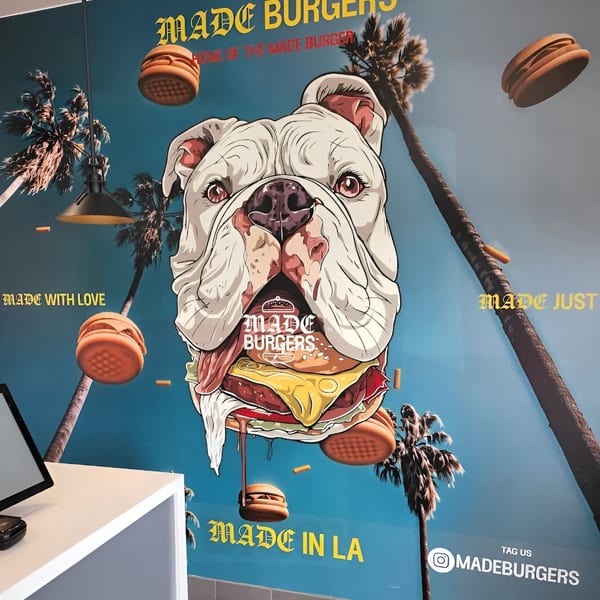 Made Burgers wall art with a bulldog eating a burger, palm trees, and floating burgers.